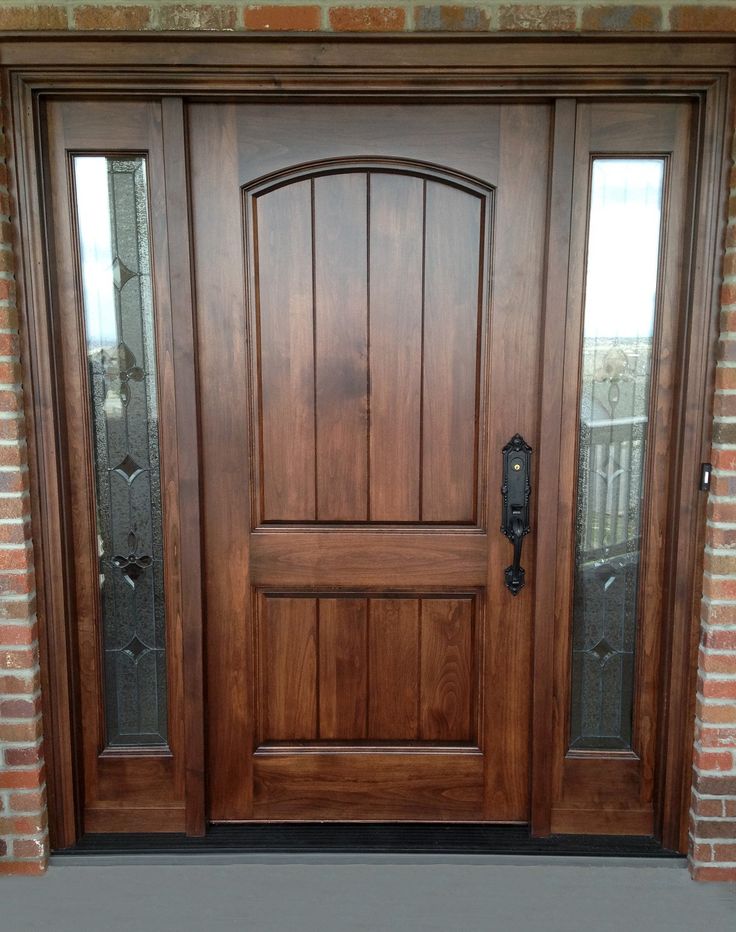 a close up of a wooden door on a brick building