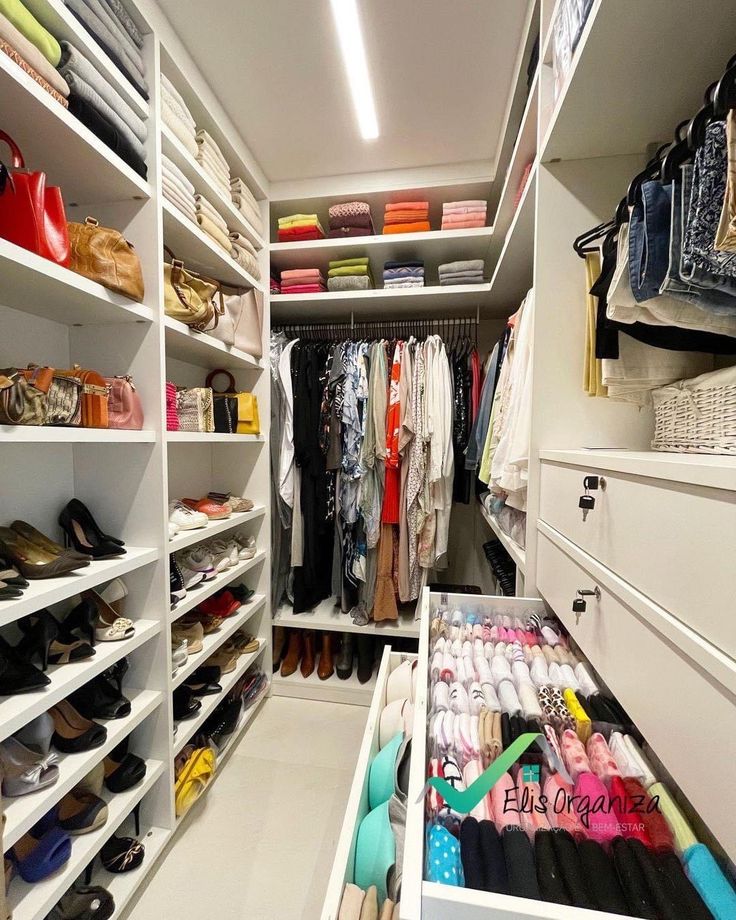 an organized closet with shoes and handbags on the shelves, clothes neatly stored in bins