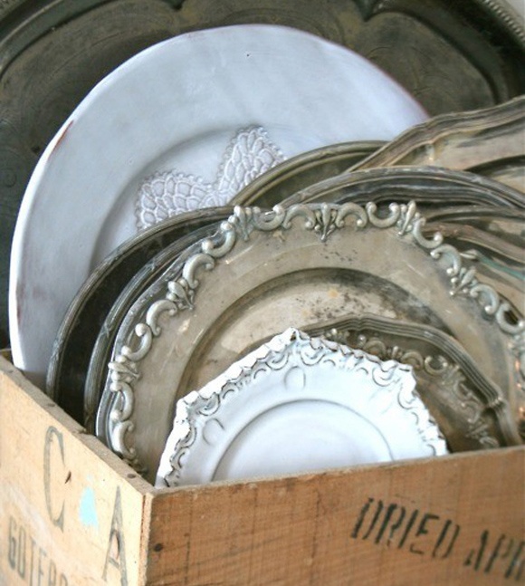 a wooden box filled with lots of plates