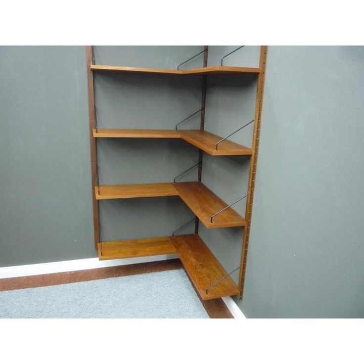 an empty room with shelves and carpeting in the corner, there is no one on the floor