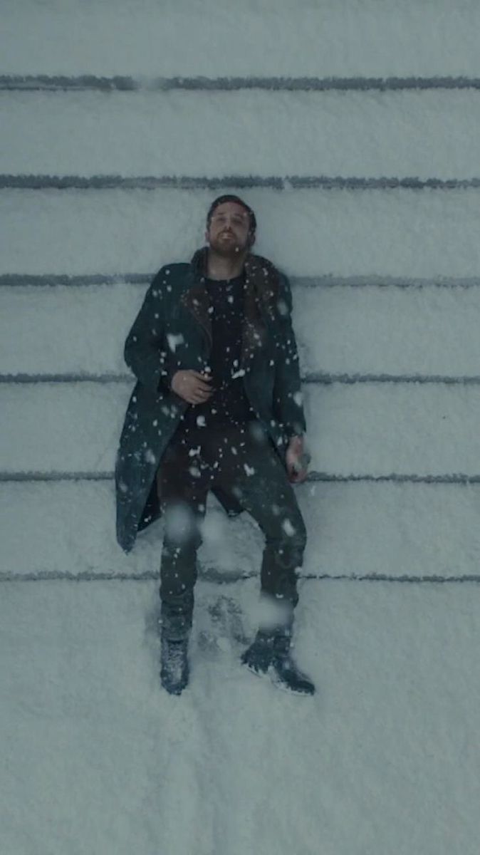 a man laying down in the snow