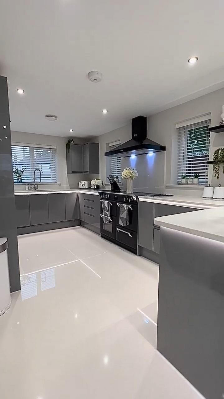 a kitchen with white floors and gray cabinets