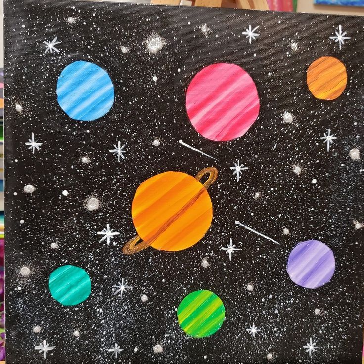 an art project with different colored planets and stars