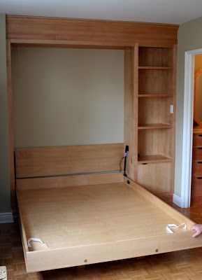 a bedroom with a bed, bookcase and dresser