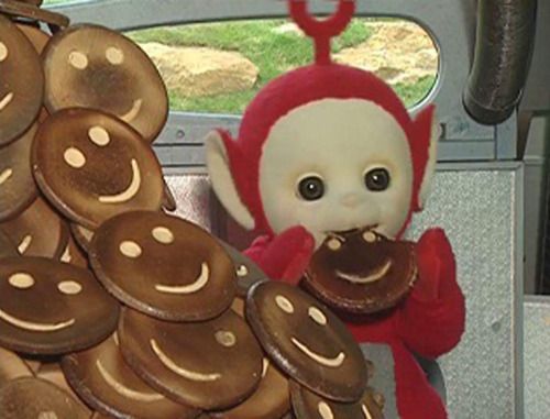 a stuffed animal sitting in the back seat of a car next to a pile of cookies