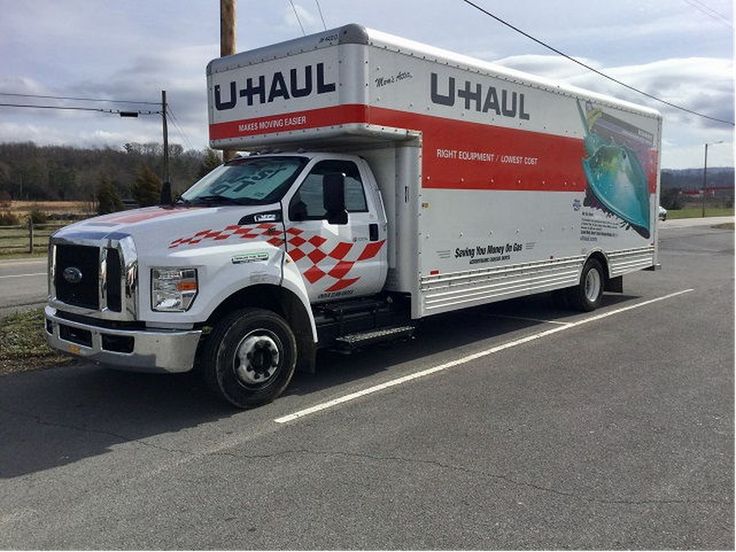 a delivery truck is parked on the side of the road in front of an empty street