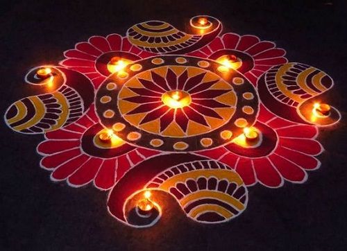 a decorated rangdi with lit candles on the ground