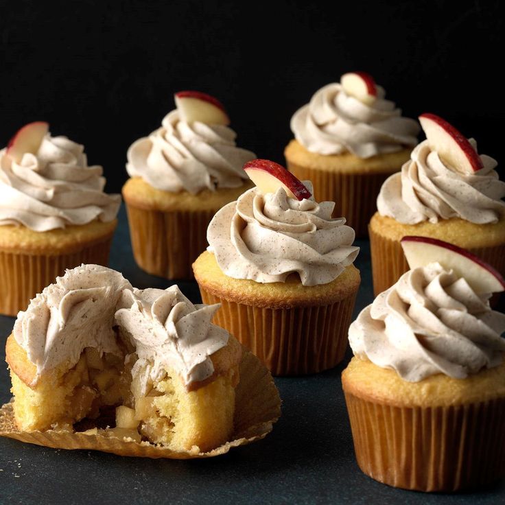 cupcakes with white frosting and apples on top