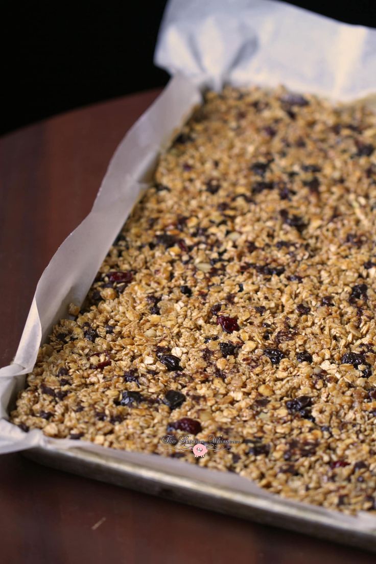 a pan filled with granola sitting on top of a wooden table