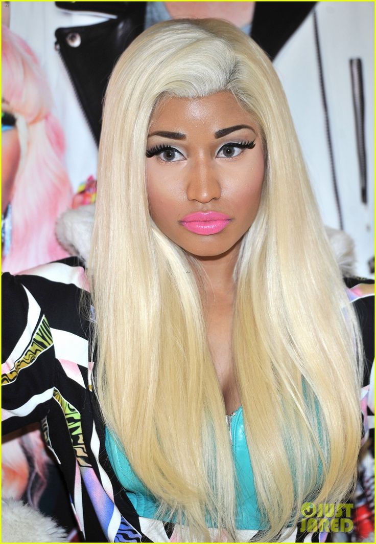 a barbie doll with long blonde hair and pink lipstick on it's lips is posed in front of a poster