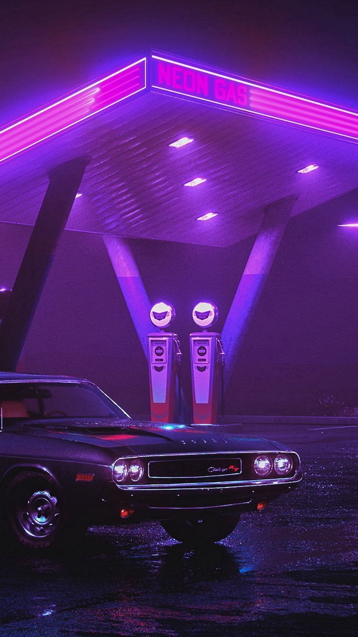 an old car parked in front of a gas station with purple lights on the roof