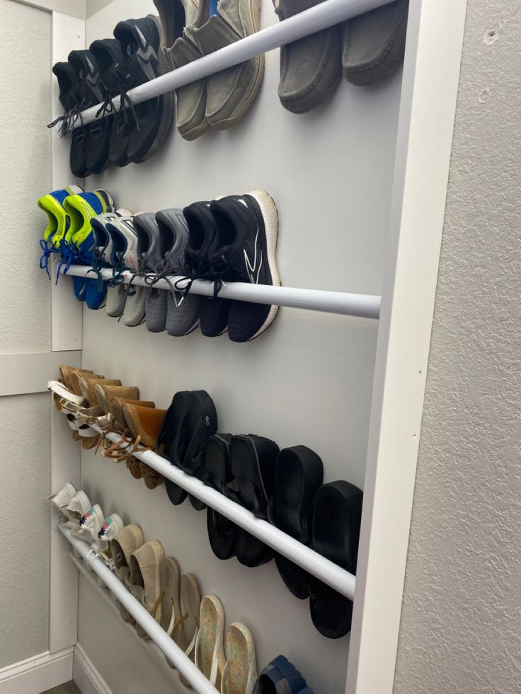 there are many pairs of shoes hanging on the wall