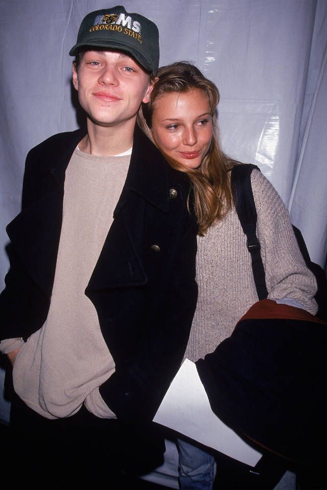 a young man and woman posing for a photo