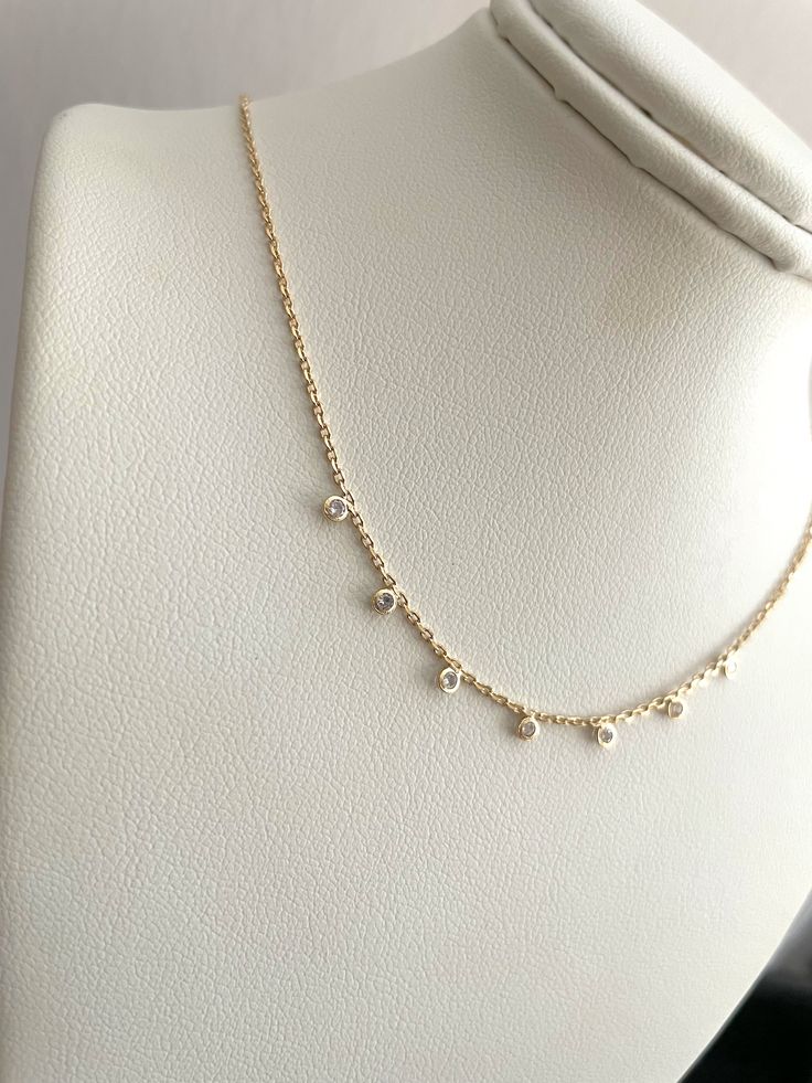 This Zirconia dots necklace is perfect for everyday elegance. Crafted with gold filled material and 5 sparkling zirconia dots, this dainty necklace is sure to make a statement. Upgrade your wardrobe with this timeless piece! Dot Necklace, Everyday Elegance, Dainty Necklace, Timeless Pieces, Gold Filled, Dots, Sparkle, Bracelet, Collar