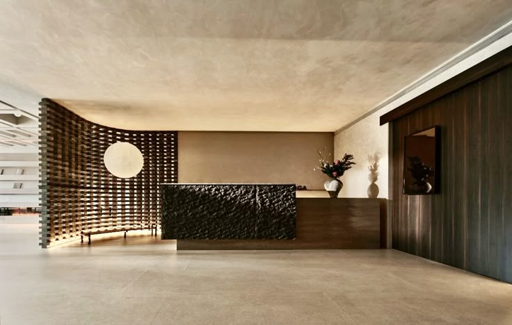 an empty lobby with a reception counter and vases