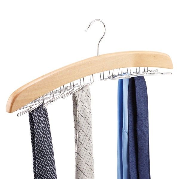 three ties are hanging on a wooden hanger