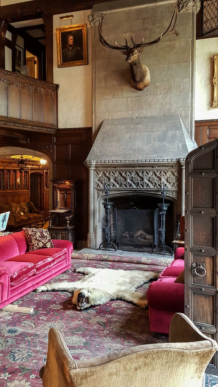 a living room filled with furniture and a fire place in the middle of a room