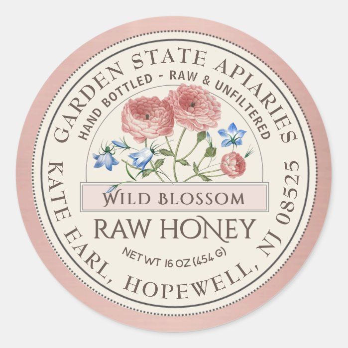 the label for wild blossom raw honey is shown in pink, white and blue colors