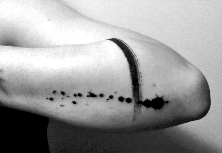 a woman's arm with black dots on it