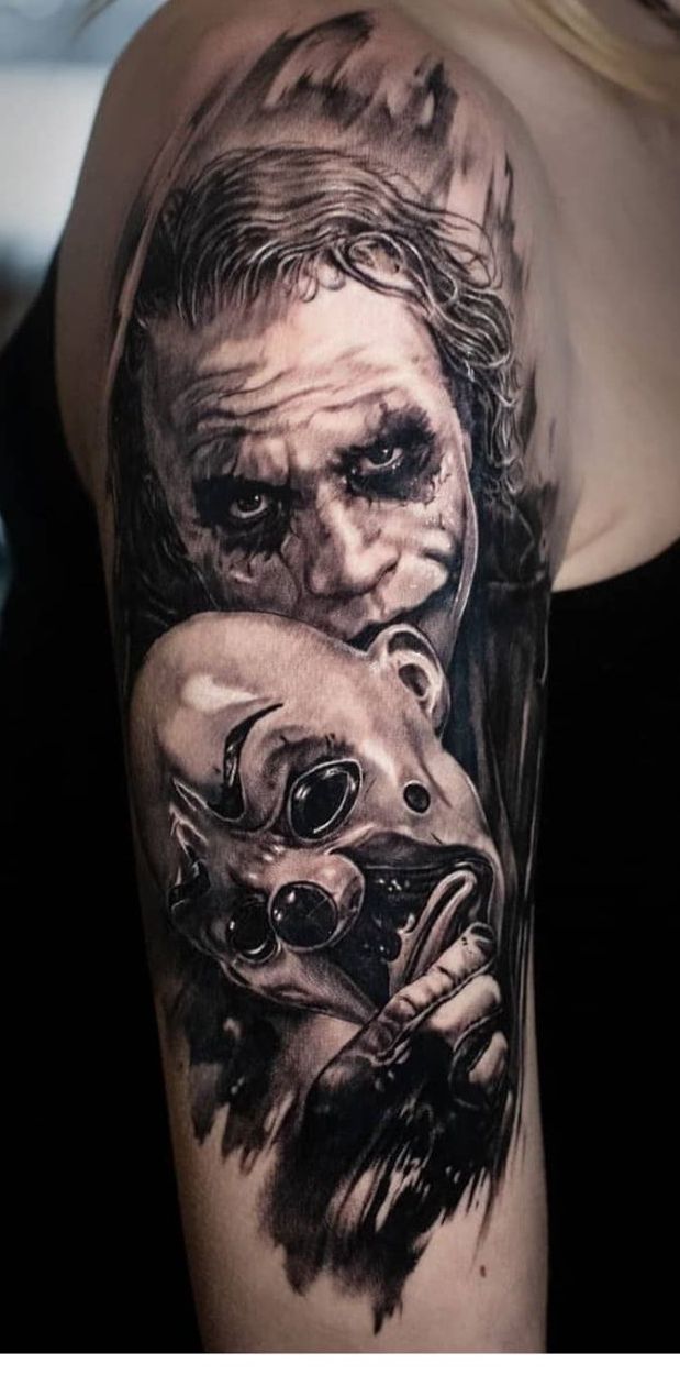 a woman with a tattoo on her arm has a drawing of the joker and his skull