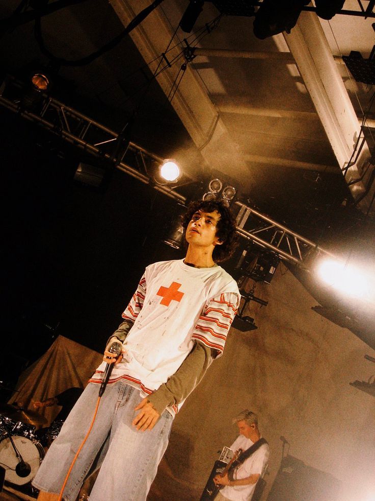 a young man standing on top of a stage