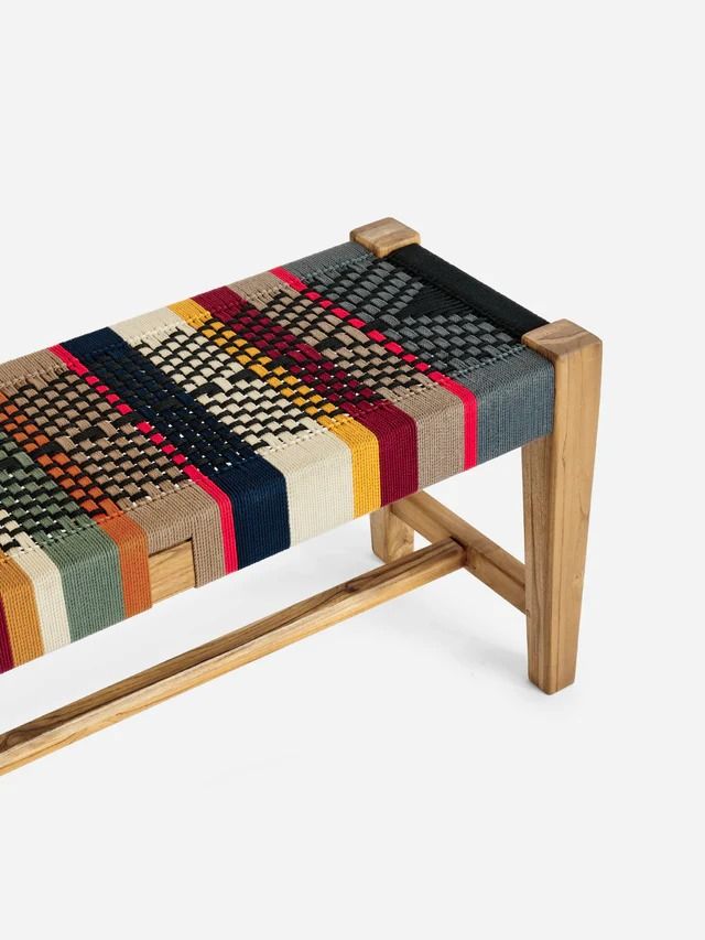 a multicolored bench with wooden legs