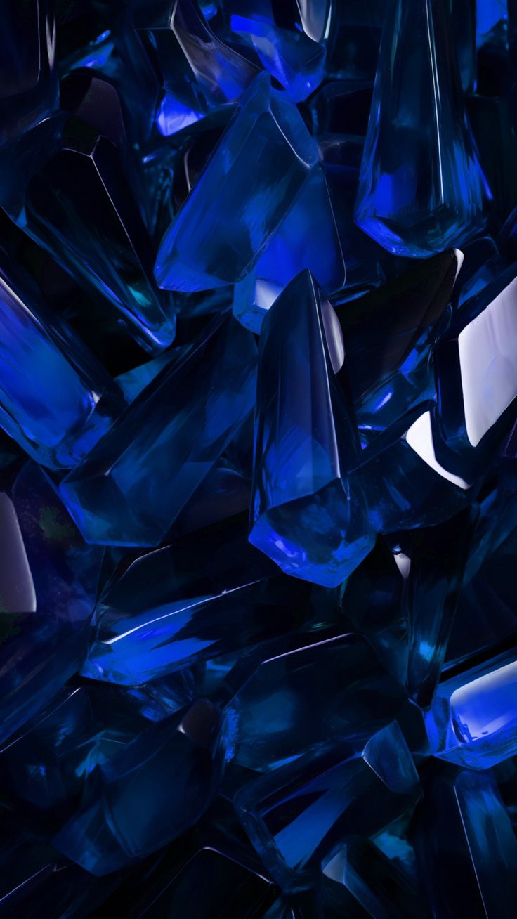 many blue glass pieces are stacked together