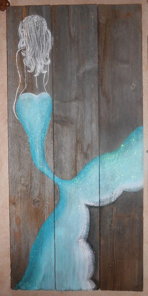 a piece of wood with a drawing of a woman in a blue dress on it