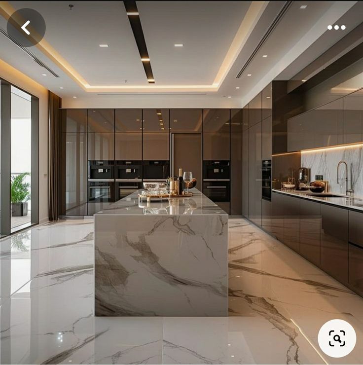 a large kitchen with marble counter tops and stainless steel appliances