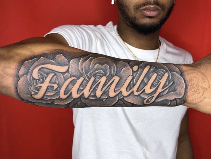 a man with a tattoo on his arm that says family