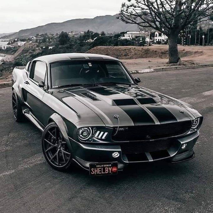 a black and silver mustang parked on the street