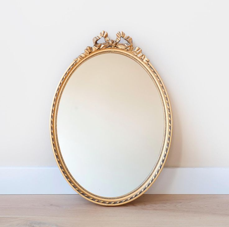 a mirror sitting on top of a wooden floor