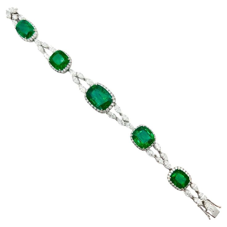 Emerald and diamond bracelet, featuring five cushion-shaped natural emeralds weighing 35.52 total carats. The five emeralds graduate in size from the center and are each framed by round brilliant-cut diamonds. Joined by twenty-nine marquise and one round brilliant-cut diamond. Diamonds weighing 9.41 total carats. Hidden clasp with double safety. Measuring 7" in overall length. Accompanied by the GIA Emerald Origin Report, numbered 6223920041 and dated 5-19-2023, indicating the emeralds are natural and of Zambian origin. Emerald Bracelets, Graff Diamonds, 3 Carat Diamond, Modern Bracelets, Emerald Bracelet, Gold Geometric, Emerald Cut Diamonds, Gorgeous Jewelry, Emerald Diamond