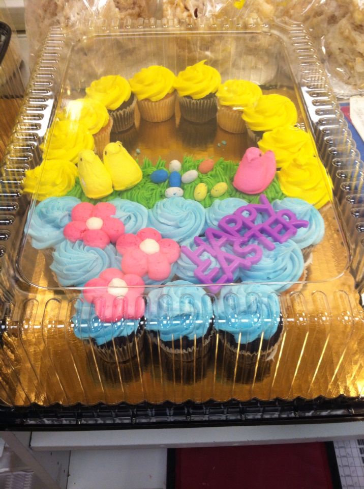 cupcakes with frosting and icing in the shape of flowers on a tray