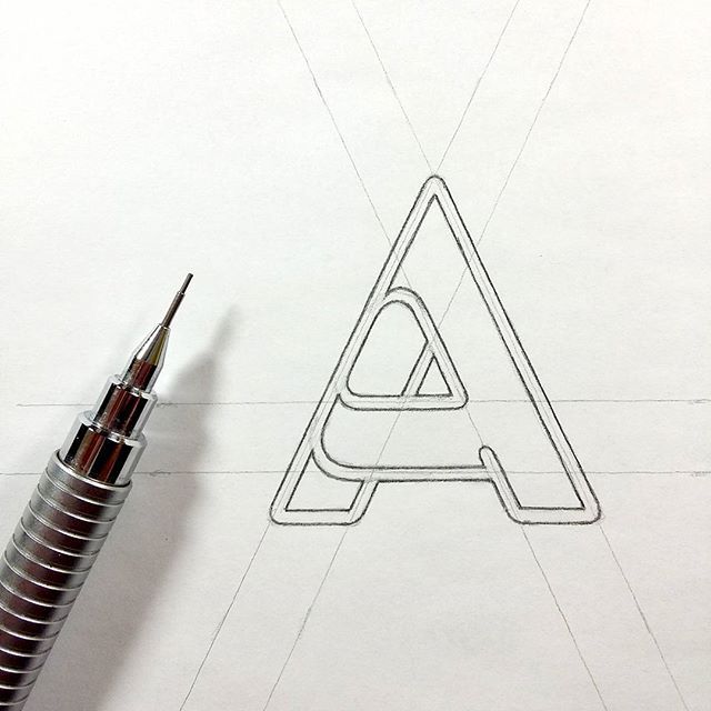 the letter a is drawn on paper with a pen