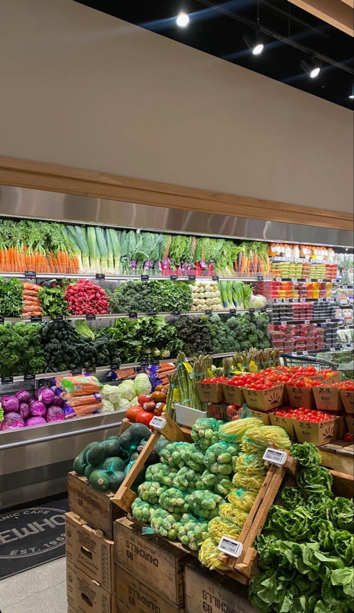 the produce section of a grocery store filled with fresh fruits and vegetables