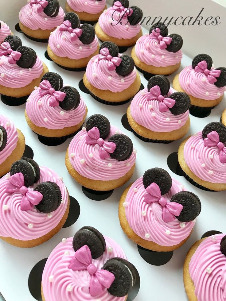 cupcakes with pink frosting and minnie mouse decorations