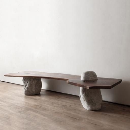 two stone benches sitting on top of a hard wood floor