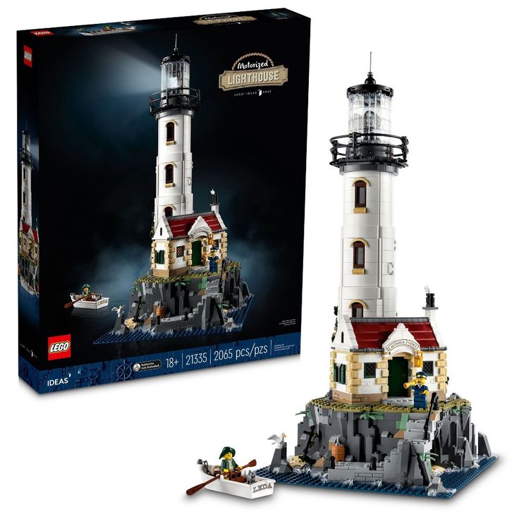 a lego lighthouse with a boat in front of it and a box on the side