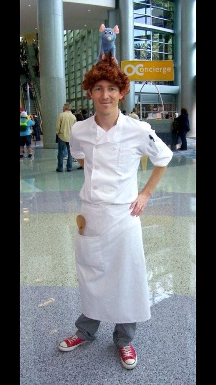 a man dressed as a chef standing in an airport