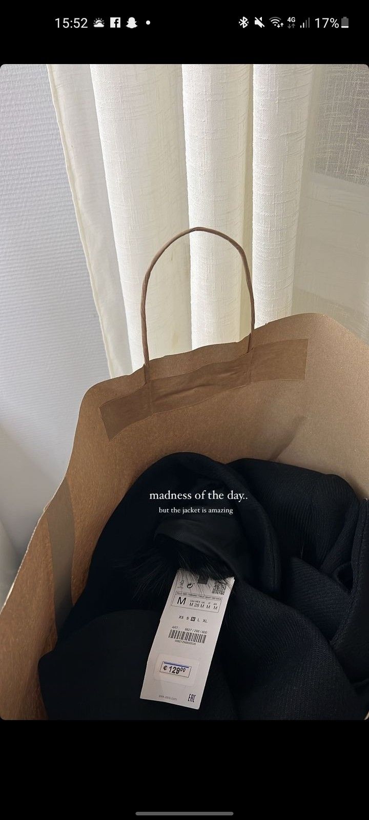 an open brown paper bag sitting on top of a table next to a white curtain