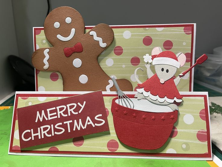 a christmas card with a teddy bear and a ginger in a red cup on it