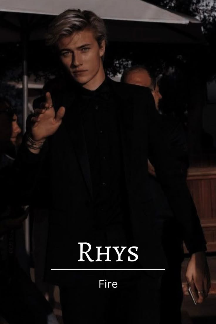 a man in a black suit and tie with the words rhys on it