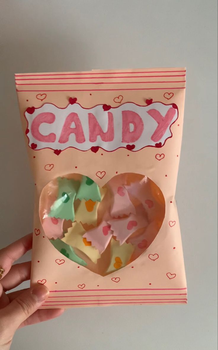 someone holding up a candy card with hearts on it