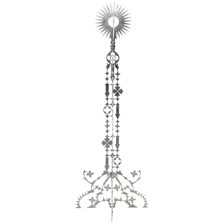 a tall metal pole with a clock on it's side and an ornate design at the top