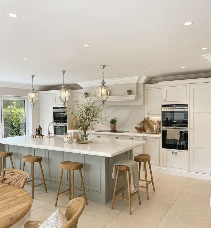 a large kitchen with an island and bar stools