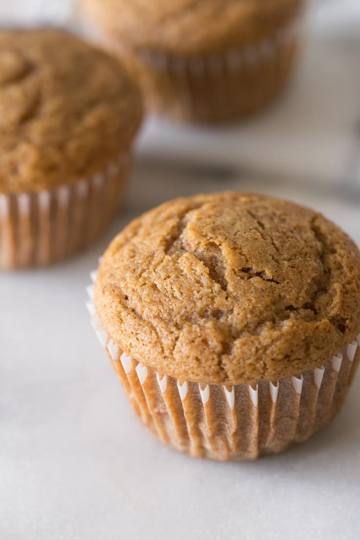 three muffins sitting on top of a white counter