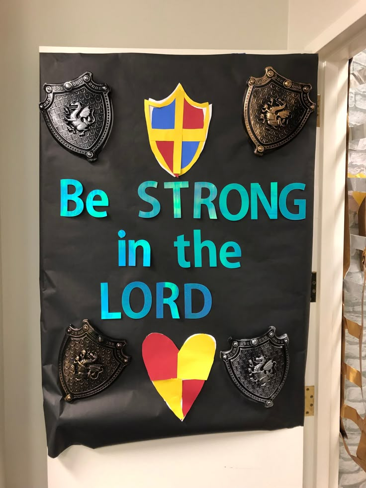 a bulletin board that says be strong in the lord with shields and shield on it