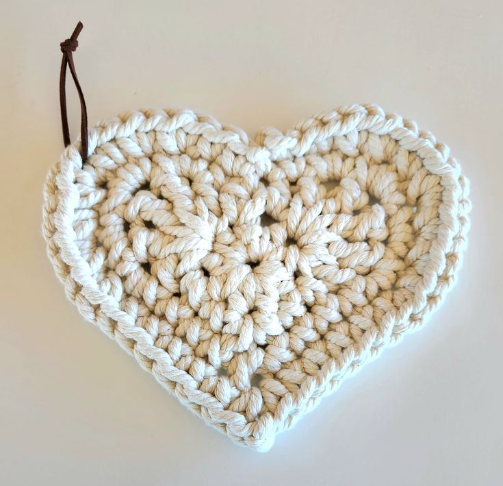 a crocheted heart hanging on a string