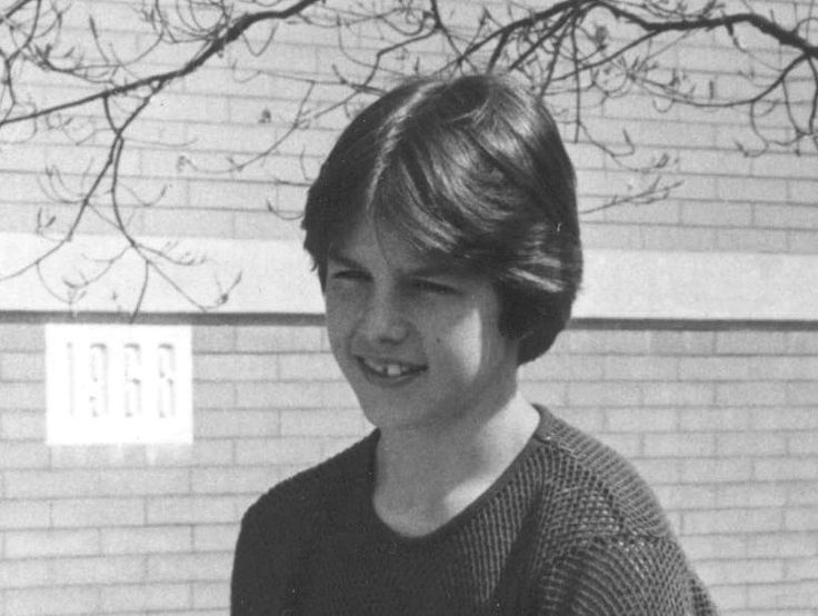 a young boy smiling in front of a brick building with the words, how do you know?